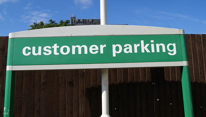 Retail store A customer parking sign outside a retail store, indicating designated parking spaces for shoppers to conveniently access the store.