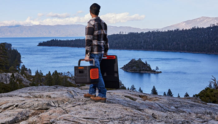 Cost-effective and reliable solar charger and generator options Hiker carrying solar chargers and generators for sustainable energy during remote mountain trekking and wilderness travel.