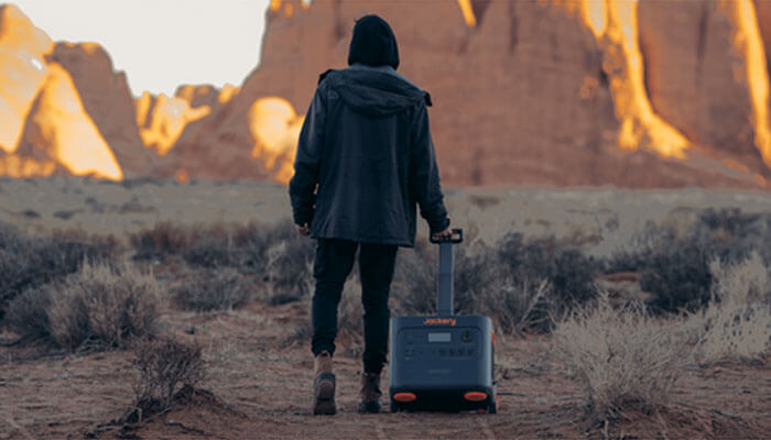 Exceptional portability Explorer pulling rugged solar chargers and generators through desert terrain, highlighting durable off-grid energy solutions.