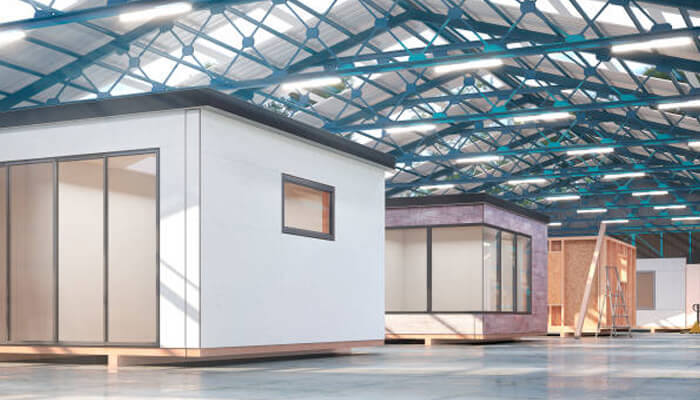 Factory-built homes Inside a factory, showing the assembly of prefabricated homes with clean lines and high-quality materials, illustrating the streamlined process of building factory-built homes.