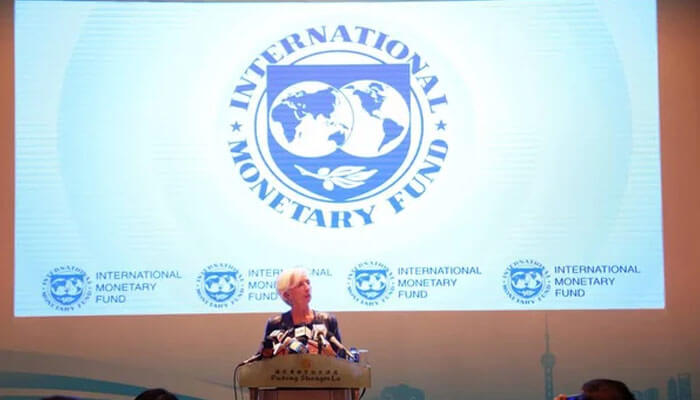 International monetary fund - tycoonstory | tycoonstory media International monetary fund (imf) logo displayed during a press conference, highlighting the fed role in global economic discussions.