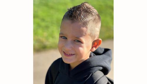 Little boy haircuts Smiling child with a spiked fade style, a trendy option for little boy haircuts.