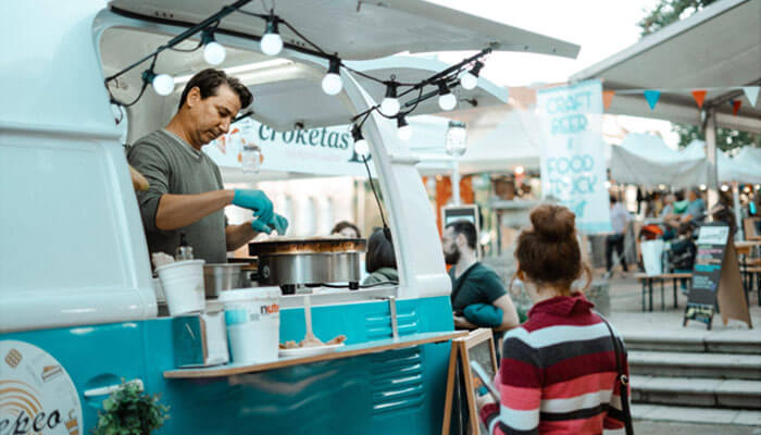 Business ideas Man preparing food at a food truck, representing entrepreneurial business ideas in the food and beverage industry.