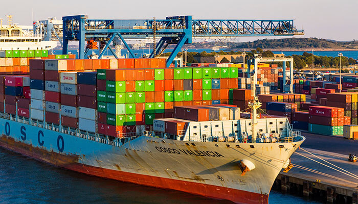 Risk management - tycoonstory | tycoonstory media Reliable international freight cargo ship loaded with shipping containers at a busy seaport, supporting global trade and logistics operations