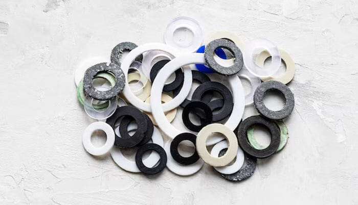 Ptfe Ptfe polymer rings and sealing gaskets arranged on a light surface, illustrating the chemistry, molecular structure, and industrial applications of ptfe materials.