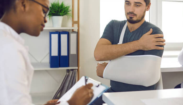 The first visit after the crash Patient undergoing after-crash checkup with a doctor after sustaining arm injuries in a car accident.