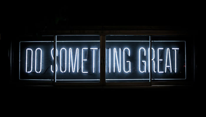 Lotteries Lotteries displayed in neon lights with the message'DO SOMETHING GREAT,' symbolizing the role of lotteries in wealth distribution and social mobility.