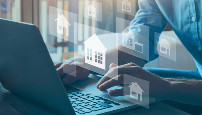 Your property you know - tycoonstory | tycoonstory media Real estate agent using a laptop to browse digital property listings with floating house icons representing real estate options