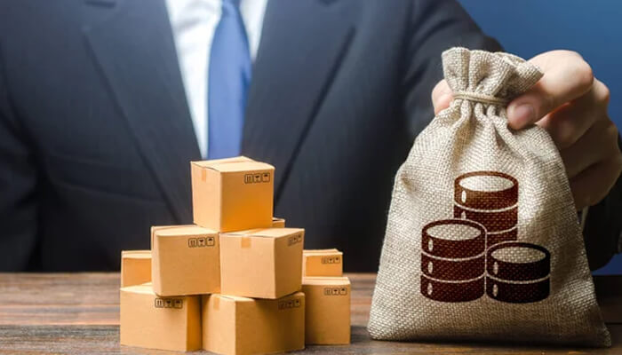 China Businessman holding a bag of money beside stacked boxes, symbolizing trade and competitive pricing in china.