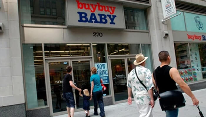 Consequences for clients - tycoonstory | tycoonstory media Bankruptcy: a family walking into a buybuy baby store, with a'Now Hiring' sign in the window, welcoming customers and job seekers.