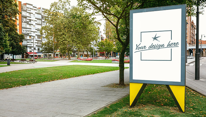 Cost-effective A blank outdoor signage frame placed in a park, demonstrating the impact of signs and banners in creating visibility for businesses in high-traffic areas.