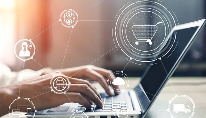 Online vape shop Person using a laptop with digital shopping icons, symbolizing browsing and purchasing vaping products from an online vape shop.