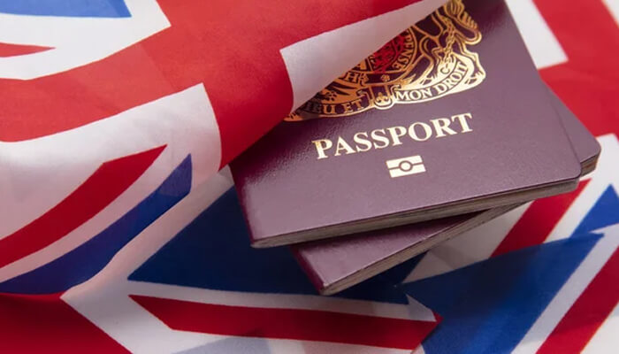 Eligibility criteria - tycoonstory | tycoonstory media British passport resting on the uk flag, symbolizing immigration and business opportunities through the innovator visa.