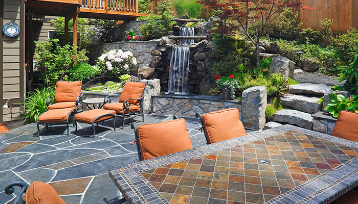 Focus on creating a fabulous outdoor space - tycoonstory | tycoonstory media House backyard featuring a stylish outdoor patio and landscaped garden area.