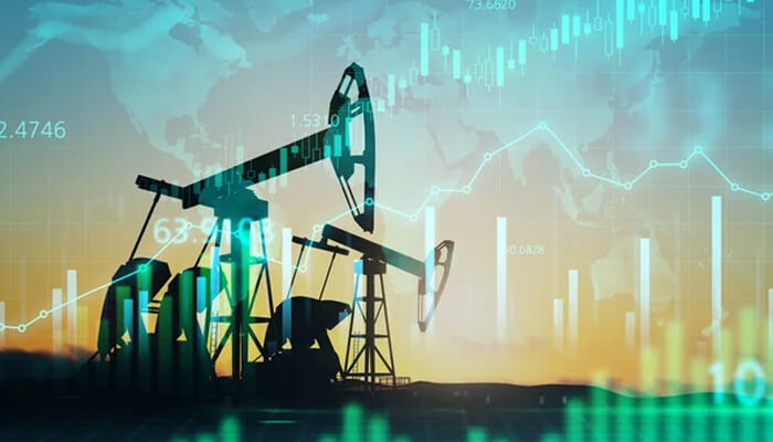 Crude oil forecast Silhouette of oil pumps with a backdrop of stock market graphs and data, symbolizing the volatility and trading of crude oil in the global economy.