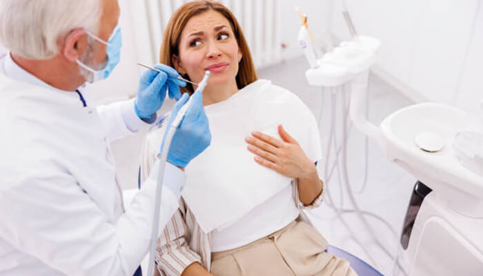 Dentist Dentist consulting with a patient during a dental examination and explaining treatment options in a clean office