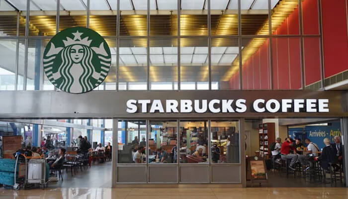 Jerry baldwin Starbucks coffee storefront in a busy terminal representing the legacy linked to jerry baldwin.