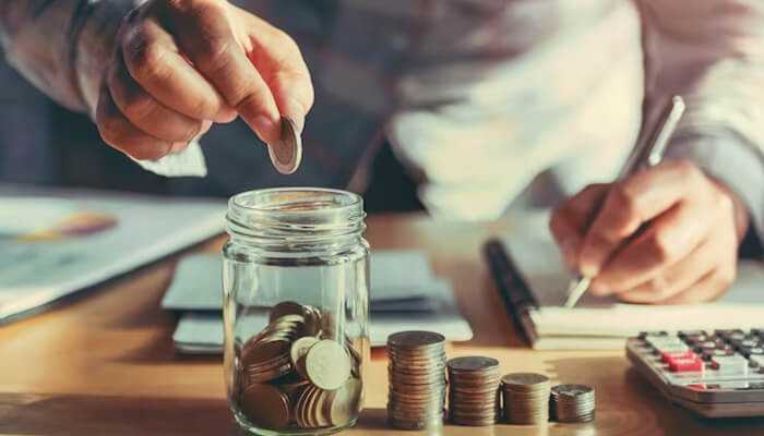Cost savings A managers counting coins and organizing financial documents in the office, demonstrating financial management skills.