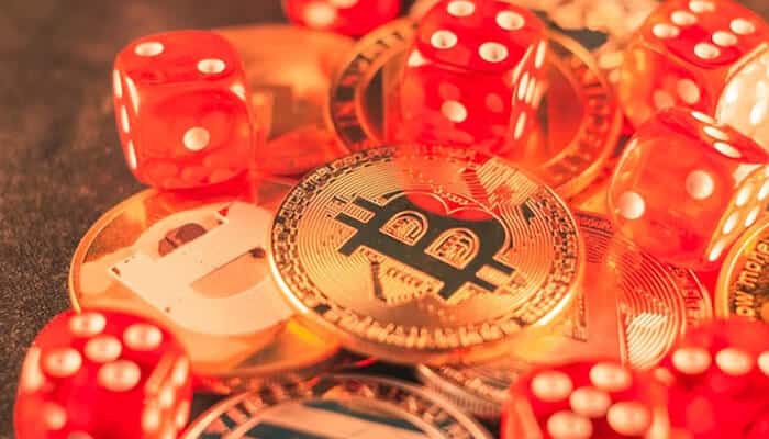 Cryptocurrency gambling Bitcoin and digital coins surrounded by red dice, illustrating the rise of cryptocurrency gambling and blockchain-based casinos.