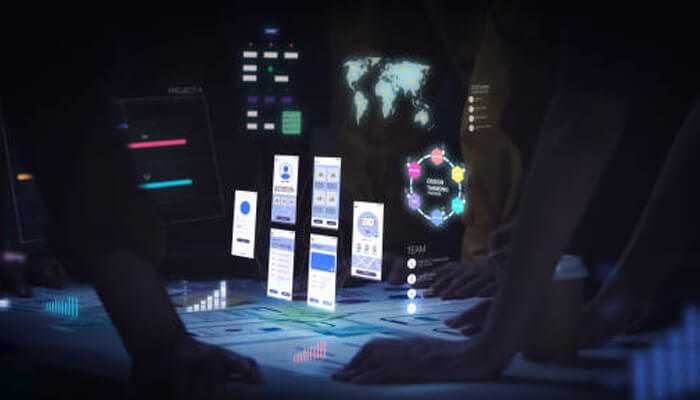 Accessibility space Digital accessibility space with teams working around an interactive table displaying futuristic interface elements and data visuals.