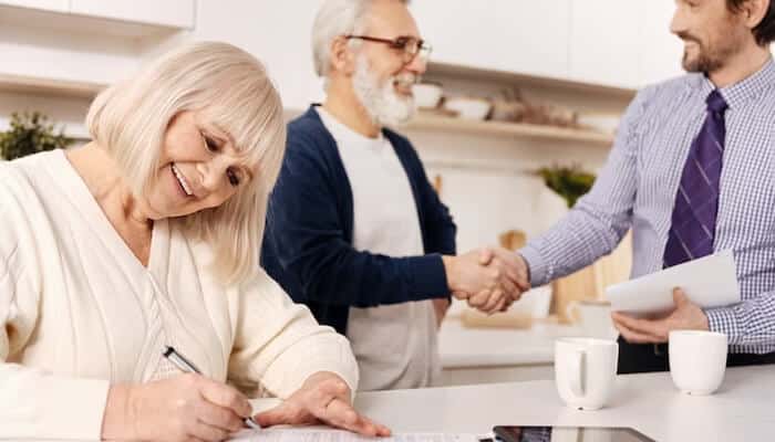 Newretirement - tycoonstory | tycoonstory media Newretirement planning moment featuring seniors finalizing retirement decisions, signing documents, and discussing long-term financial security.