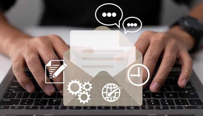 Onboarding email Hands typing on a laptop keyboard with digital email and communication icons overlayed, representing messaging and workflow tools.
