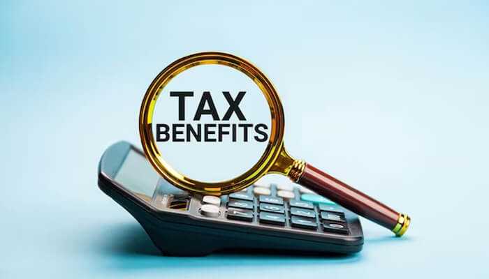 What are tax benefits Gold iras tax benefits illustrated with a magnifying glass highlighting tax benefits over a calculator, representing tax-advantaged retirement investing.