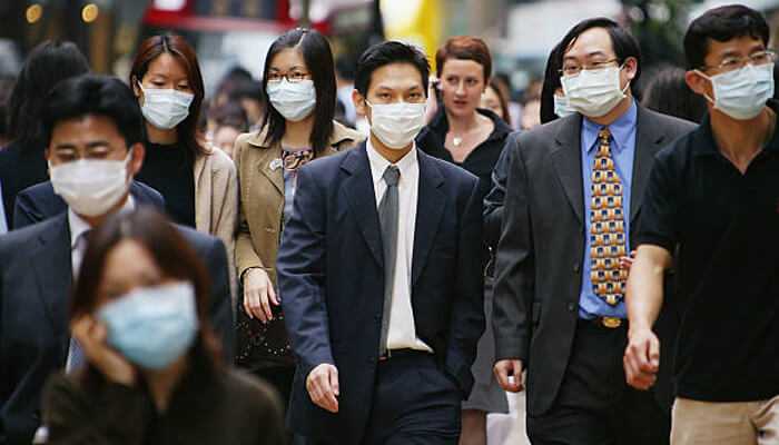 Chinese social media People in china wearing face masks while walking through a busy city street during public health precautions
