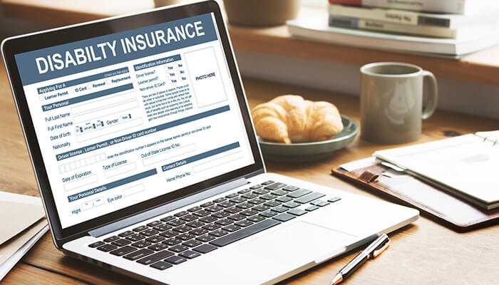 How to improve your chances of approval A laptop displaying a disability insurance application form on the screen, representing the process of filing disability claims for head injuries.