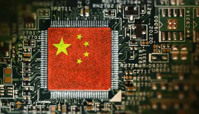 China A microchip on a green circuit board with the flag of china (red field and five yellow stars) printed directly onto the chip's surface.