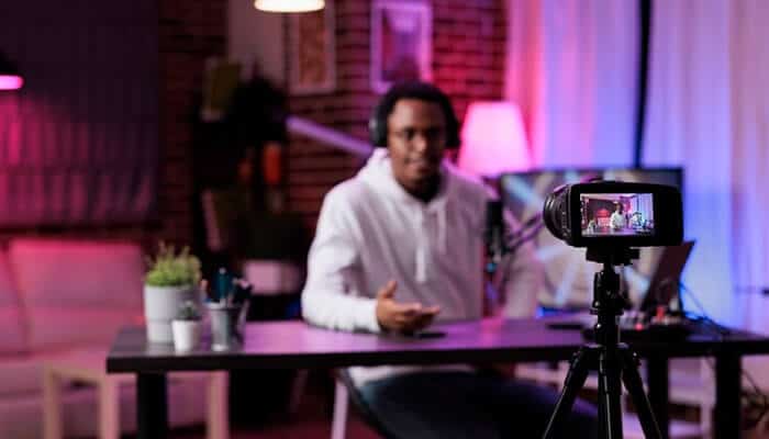Video marketing A content creator in a studio setting, recording a video with a camera on a tripod, creating engaging content for an audience, likely involving video marketing techniques.