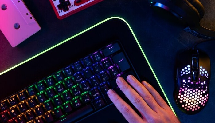 Gaming mice Close-up of a gaming setup with a colorful led keyboard, gaming mouse, and other accessories, highlighting a high-tech environment for immersive gaming experiences.