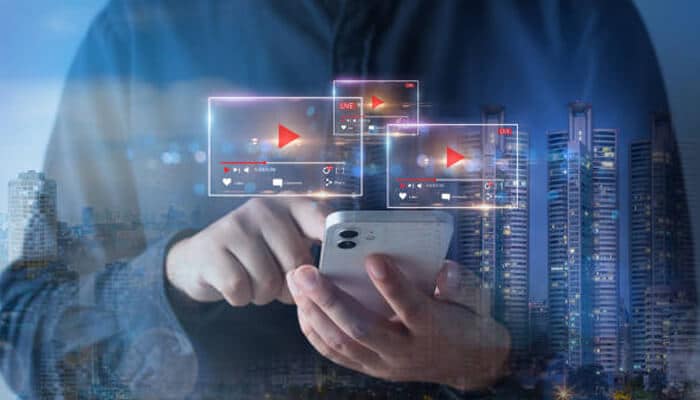 Video marketing A person interacting with a mobile phone showing multiple video player overlays, highlighting the concept of video marketing in a digital and futuristic setting.