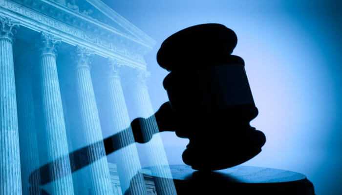 Sackler family Silhouette of a judge’s gavel against a courthouse background, representing legal decisions and justice.