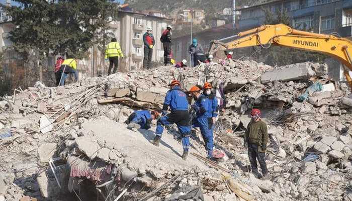 Earthquake Rescue workers searching through collapsed buildings after a powerful earthquake, assessing damage and saving survivors.