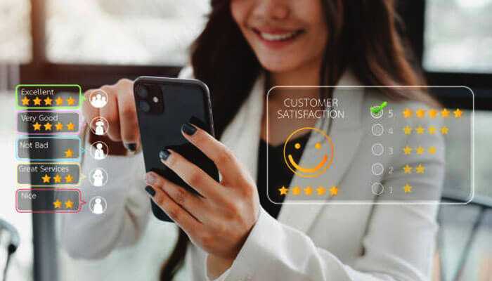 Moneyspire review a little history - tycoonstory | tycoonstory media Woman rating services on mobile with digital customer feedback icons — showcasing moneyspire customer satisfaction insights.