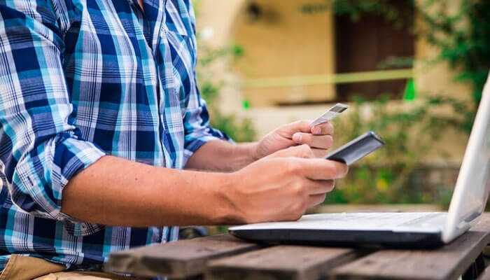 Someone managing online payments or checking their financial accounts, potentially making a payment to avoid when miss a credit card payment Miss a credit card payment and how to avoid it in the future