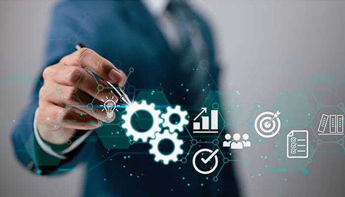 Access to expertise and latest technologies - tycoonstory | tycoonstory media A business professional pointing to digital icons representing processes, goals, analytics, teamwork, and productivity, symbolizing strategic planning, business optimization, and workflow efficiency