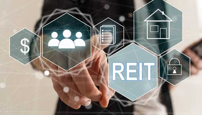Benefits of investing in reits - tycoonstory | tycoonstory media A person touching the real estate investment trusts with the money, people and security, documents symbols.
