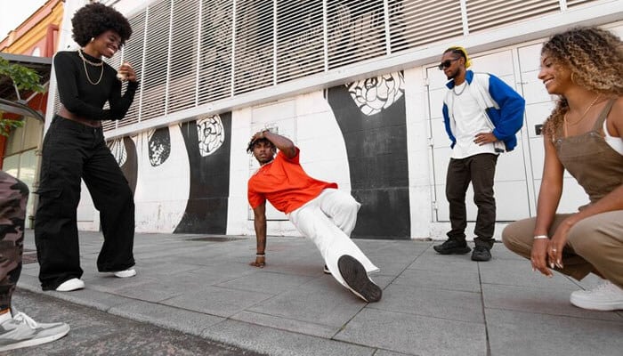 Best quality of journalism - tycoonstory | tycoonstory media Group of adults enjoying hip hop dancing and one member is breackdancing it is ideal for hip hop news website for highlighting online community.