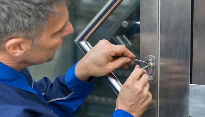 Broken or damaged locks - tycoonstory | tycoonstory media Professional technician picking or repairing a metal door lock with specialized tools, representing security services and reasons to hire a vancouver locksmith for lockouts, maintenance, and commercial security solutions.