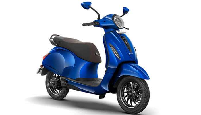 Chetak premium 2024 - tycoonstory | tycoonstory media Chetak premium 2024 is a blue electric scooter with black seat and wheels fitted head-pointed light along both the sides of handle, side mirrors.