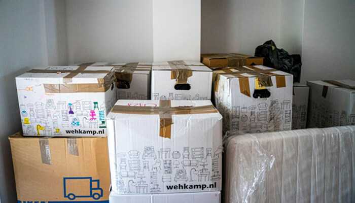 Creating personal connection - tycoonstory | tycoonstory media Sealed stack of cardboard boxes and a wrapped mattress, ready to move, all branded with wehkamp. Nl. It represents packaging for client testimonials.