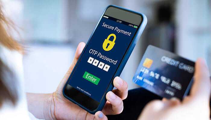 Enhanced security features - tycoonstory | tycoonstory media A person entering an otp password on a smartphone screen for a secure payment, with a credit card visible in the background, illustrating the security features of digital transactions like upi for fastag recharge.