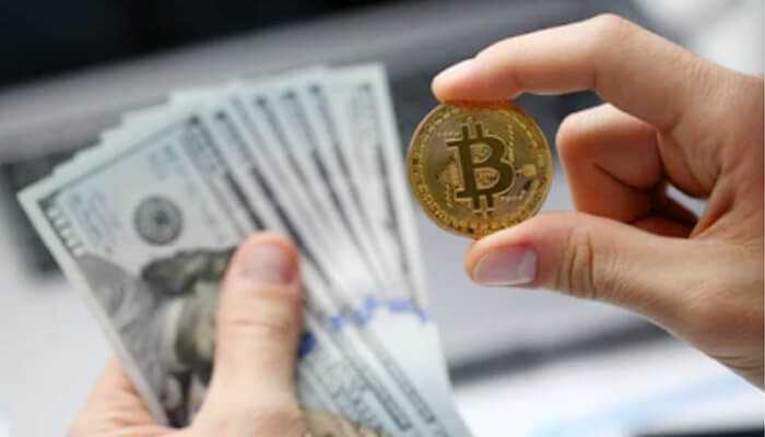Evaluating exchange liquidity - tycoonstory | tycoonstory media A person holding a bitcoin in one hand and dollars in other hand with blurred background it represents bitcoin to usd conversion.