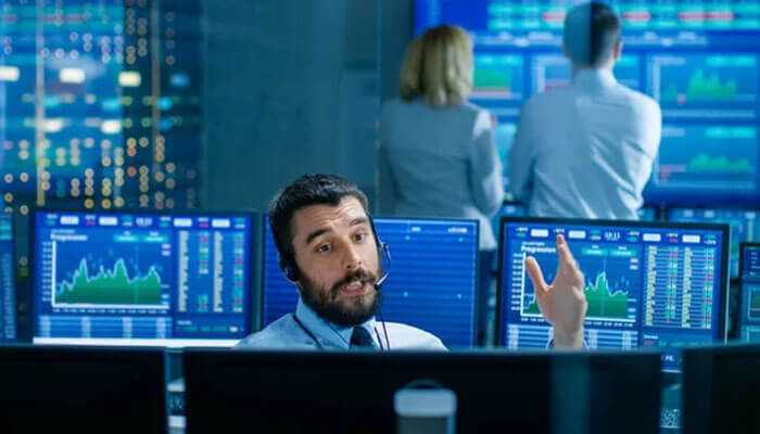 Exceptional customer support - tycoonstory | tycoonstory media Trader on headset with financial data on bprotrade platform screens in background.