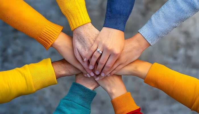 Friendship and support - tycoonstory | tycoonstory media A group of hands stacked together, symbolizing unity, support, and teamwork, reflecting the themes of friendship and resilience in parinda paar geyaa.