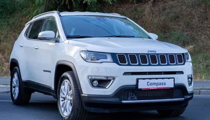 White jeep compass hybrid suv parked outdoors, featuring a sleek design with a signature grille, perfect for hybrid technology enthusiasts and adventurous driver Compass hybrid technology