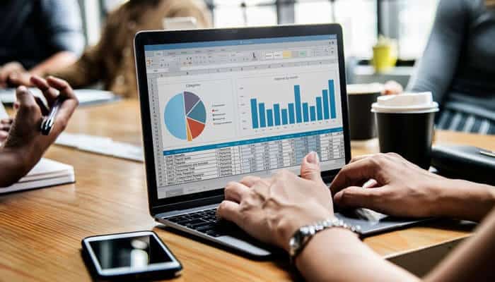 Improving data management - tycoonstory | tycoonstory media Person analyzing charts and graphs on a laptop, representing crm data analysis for improved efficiency in the pharmaceutical companies