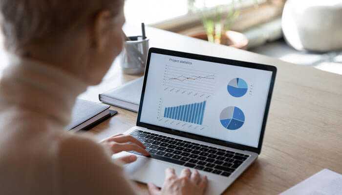 Increased sales productivity - tycoonstory | tycoonstory media A marketing professional reviewing sales data and schedules on a laptop screen, demonstrates how cpq provides accuracy and efficiency in sales processes for today’s businesses